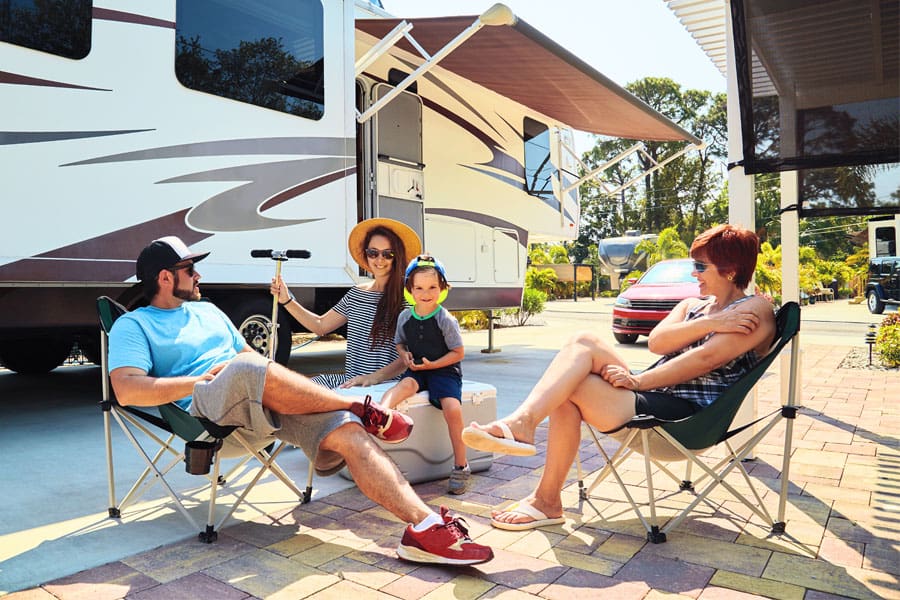 RV Insurance - Family Camped Outside Talking About the Vacation